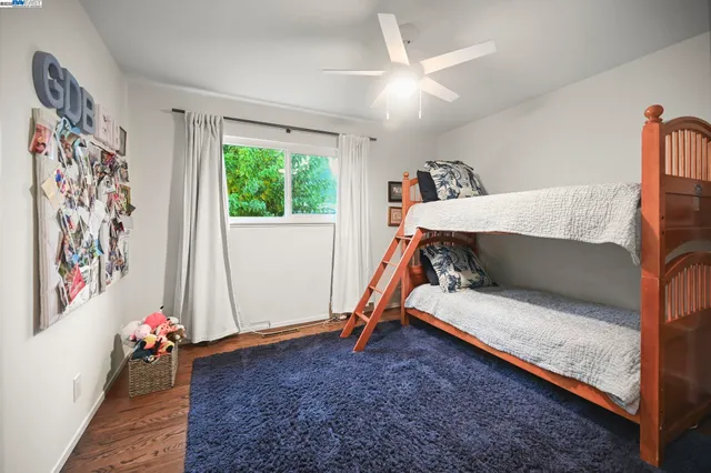 a bedroom with furniture and a large window