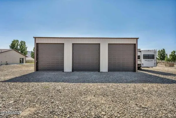 a view of a house with garden and patio
