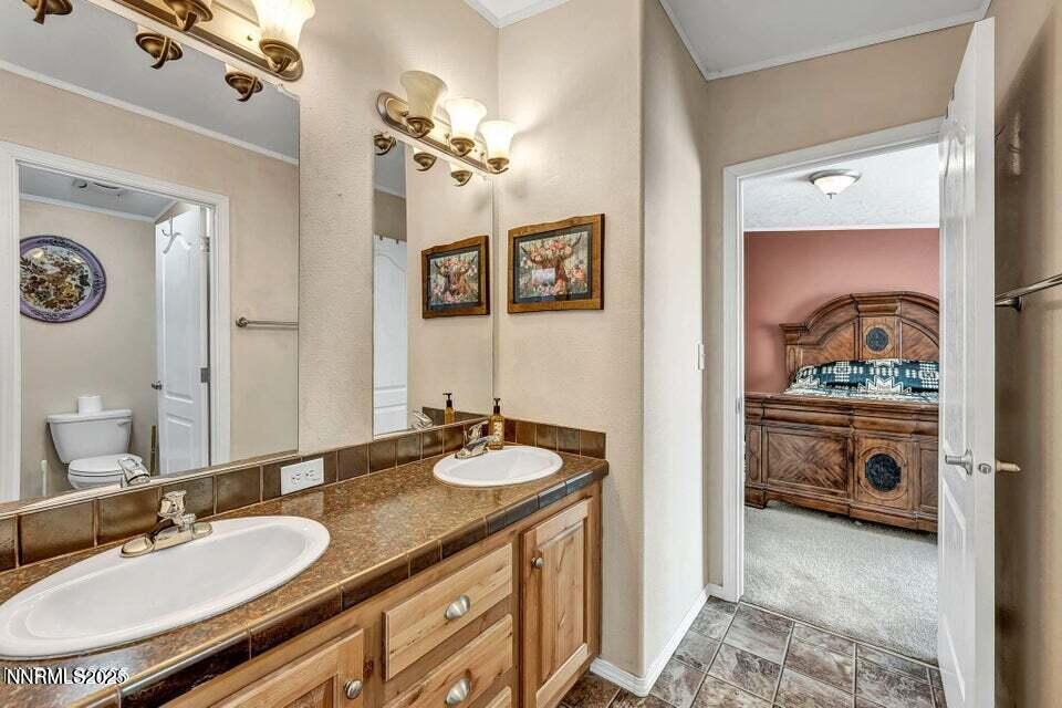 2505 Baines Road Winnemucca, NV 89445 - Photo 16 of 45 a bathroom with a granite countertop sink and a mirror
