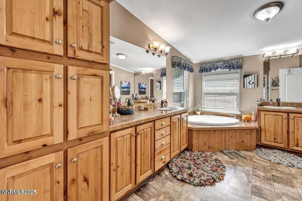 2505 Baines Road Winnemucca, NV 89445 - Photo 24 of 45 a large bathroom with a granite countertop double vanity sink a mirror and a bathtub