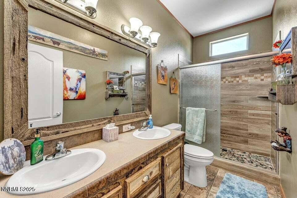 2505 Baines Road Winnemucca, NV 89445 - Photo 27 of 45 a bathroom with a granite countertop toilet sink and shower