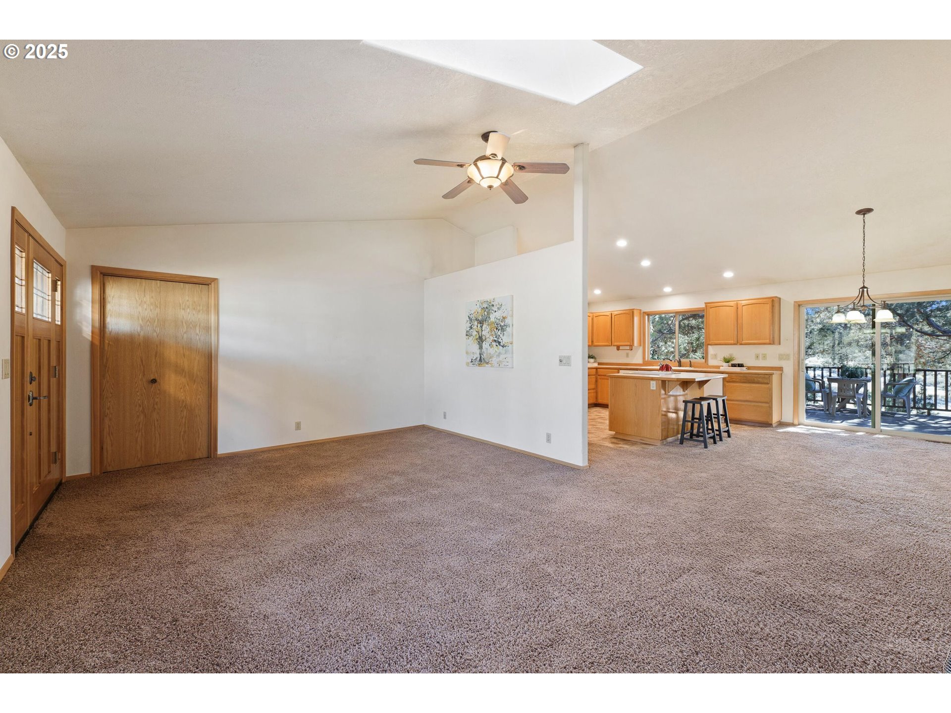64520 Joe Neil Road Bend, OR 97701 - Photo 16 of 40 a view of a livingroom with a kitchen space and a ceiling fan