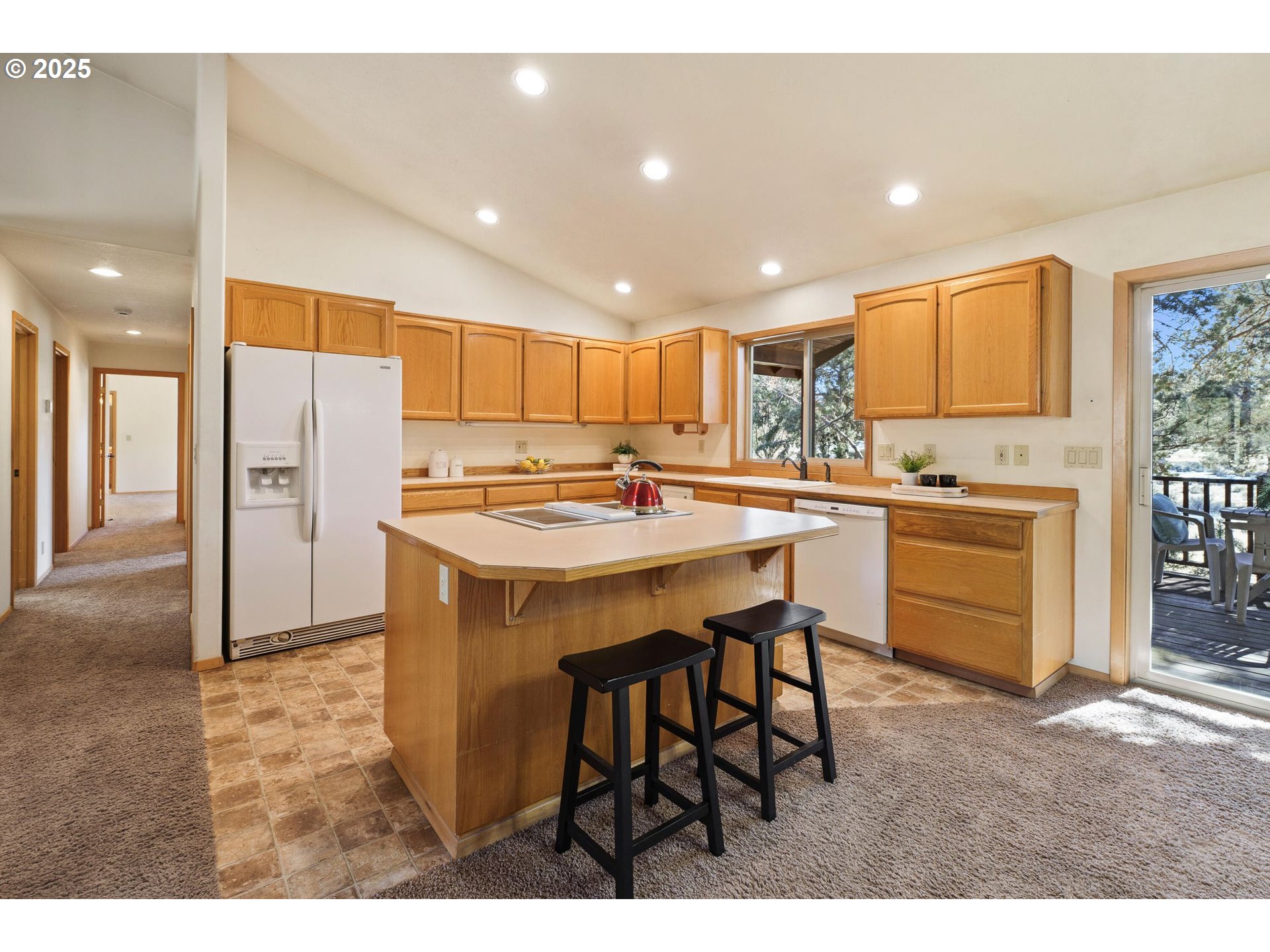 64520 Joe Neil Road Bend, OR 97701 - Photo 18 of 40 a kitchen with stainless steel appliances kitchen island granite countertop a sink and cabinets