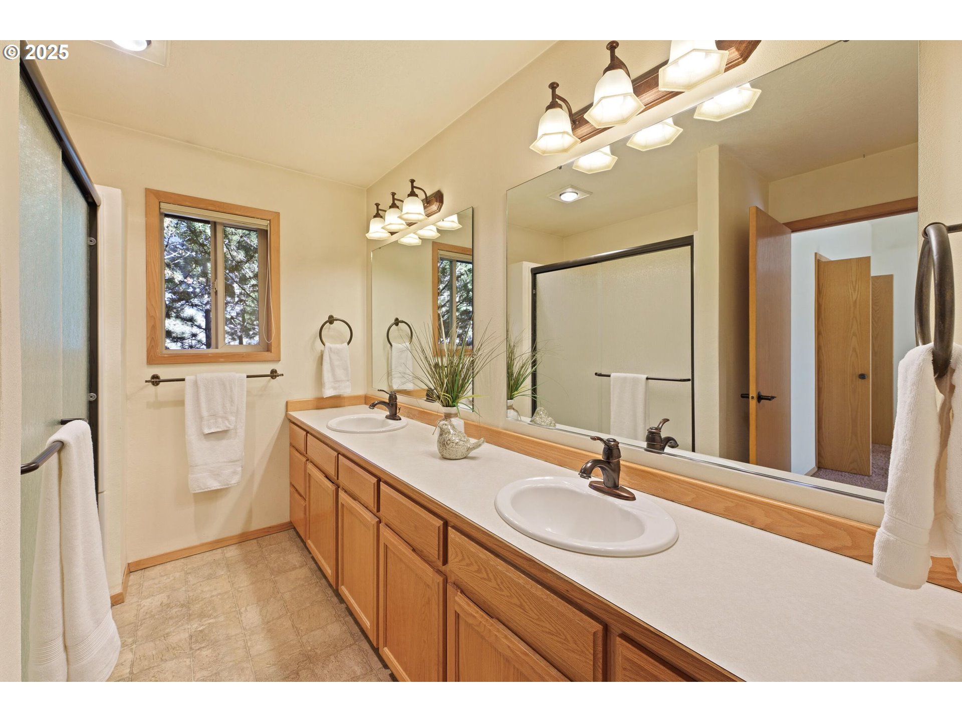 64520 Joe Neil Road Bend, OR 97701 - Photo 26 of 40 a bathroom with a sink double vanity granite and a mirror