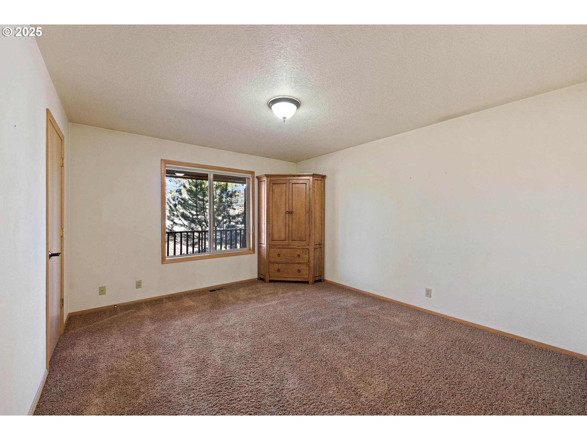 64520 Joe Neil Road Bend, OR 97701 - Photo 29 of 40 a view of an empty room with a window