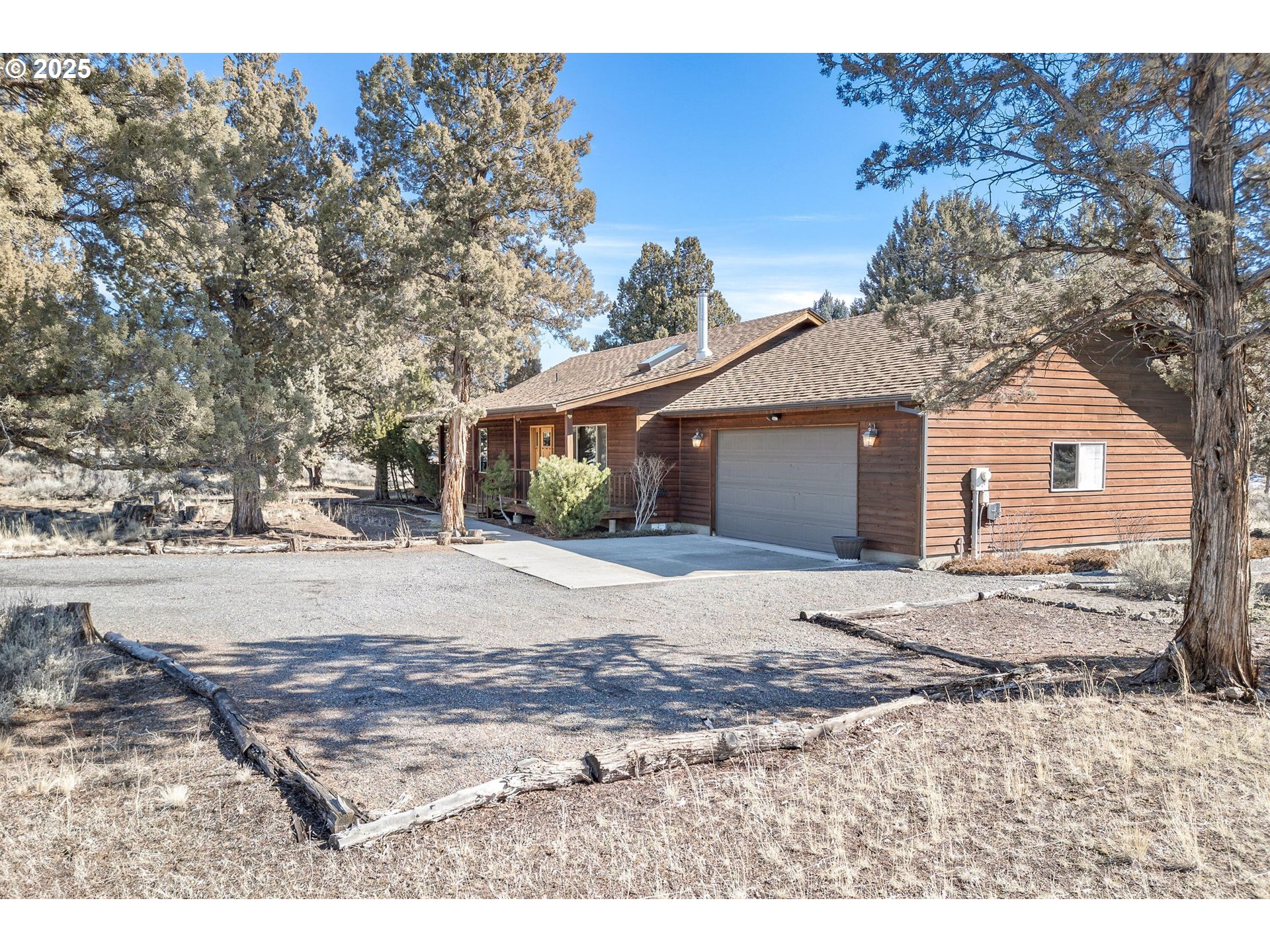 64520 Joe Neil Road Bend, OR 97701 - Photo 5 of 40 a view of a yard with a house and tree s