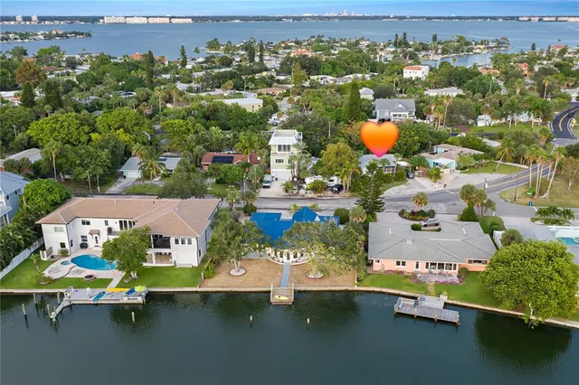an aerial view of residential houses with outdoor space and swimming pool