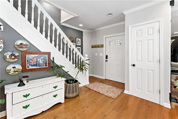 wooden floor with an entryway and livingroom with furniture