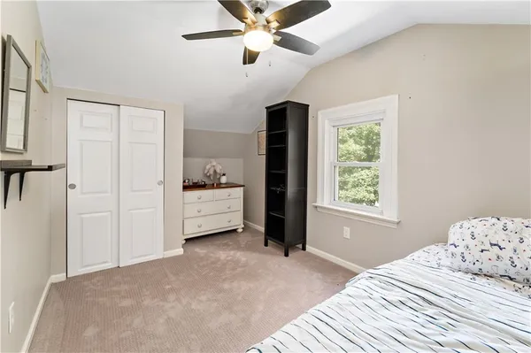 a bedroom with a bed dresser and a window