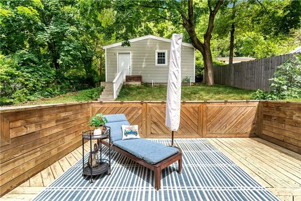 a view of a patio with table and chairs and wooden floor
