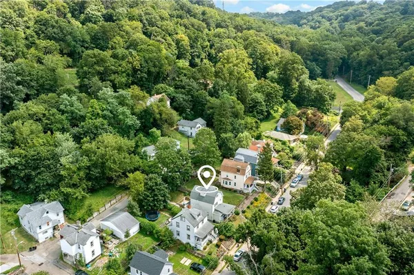 a aerial view of a house with a yard and garden