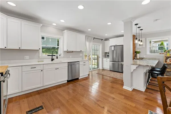 a kitchen with a sink stainless steel appliances and cabinets