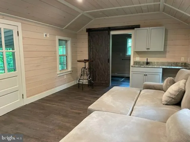 a living room with granite countertop furniture a fireplace and a window