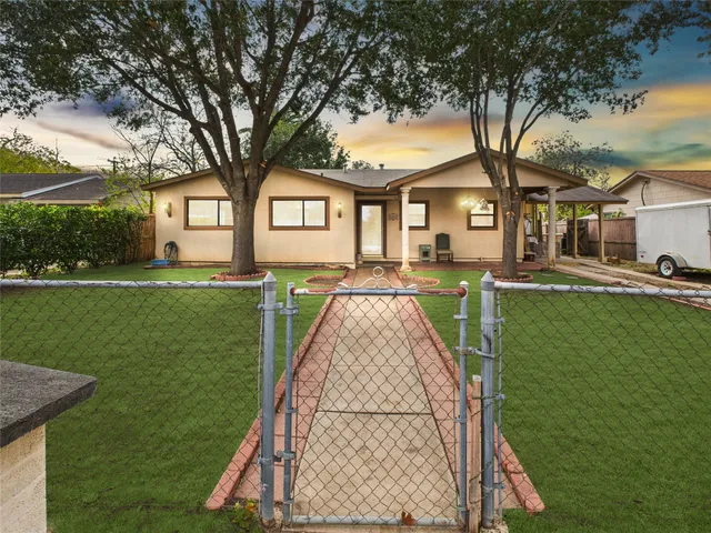a front view of a house with a yard table and chairs