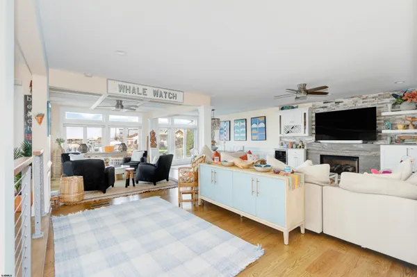 a kitchen with stainless steel appliances granite countertop a refrigerator a stove a sink and white cabinets with wooden floor