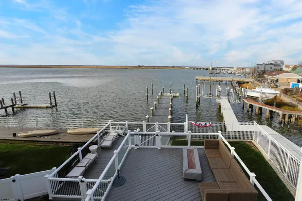 a kitchen with stainless steel appliances granite countertop a stove a sink and white cabinets