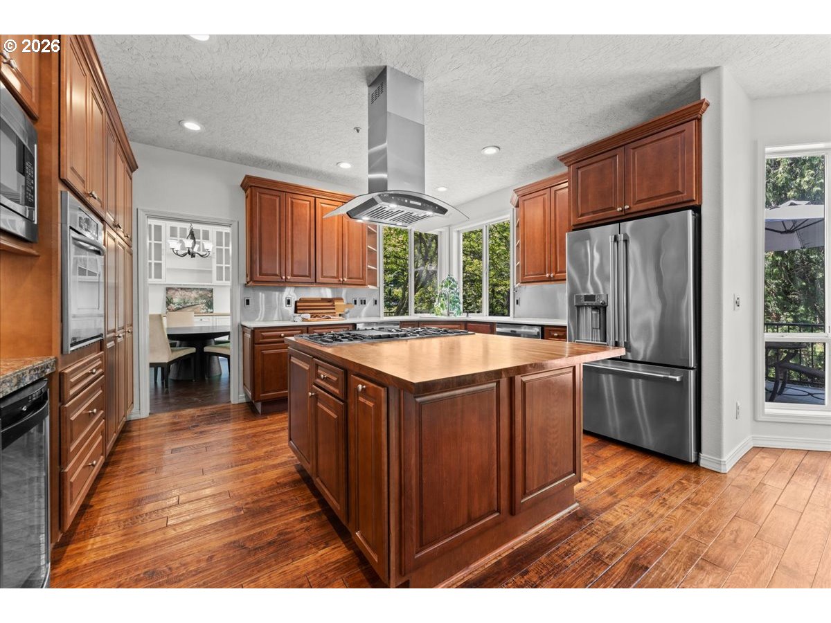 12431 Southwest 55th Place Portland, OR 97219 - Photo 6 of 40 a kitchen with stainless steel appliances granite countertop a stove refrigerator and a sink