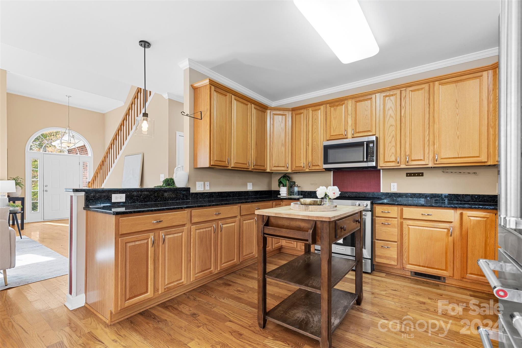7189 Windy Pine Circle Denver, NC 28037 - Photo 13 of 34 a kitchen with stainless steel appliances granite countertop a stove top oven a sink dishwasher and a refrigerator with wooden floor