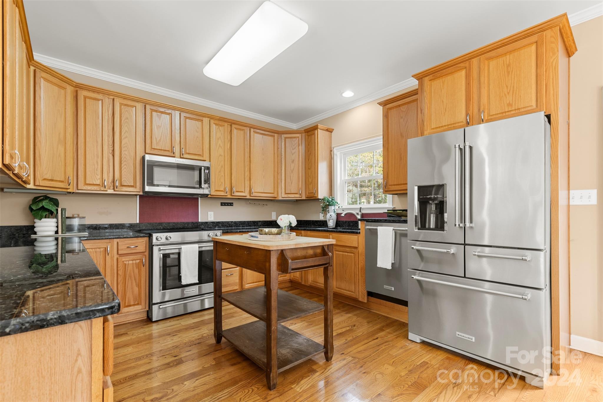 7189 Windy Pine Circle Denver, NC 28037 - Photo 14 of 34 a kitchen with a refrigerator a stove top oven a sink dishwasher and white cabinets with wooden floor