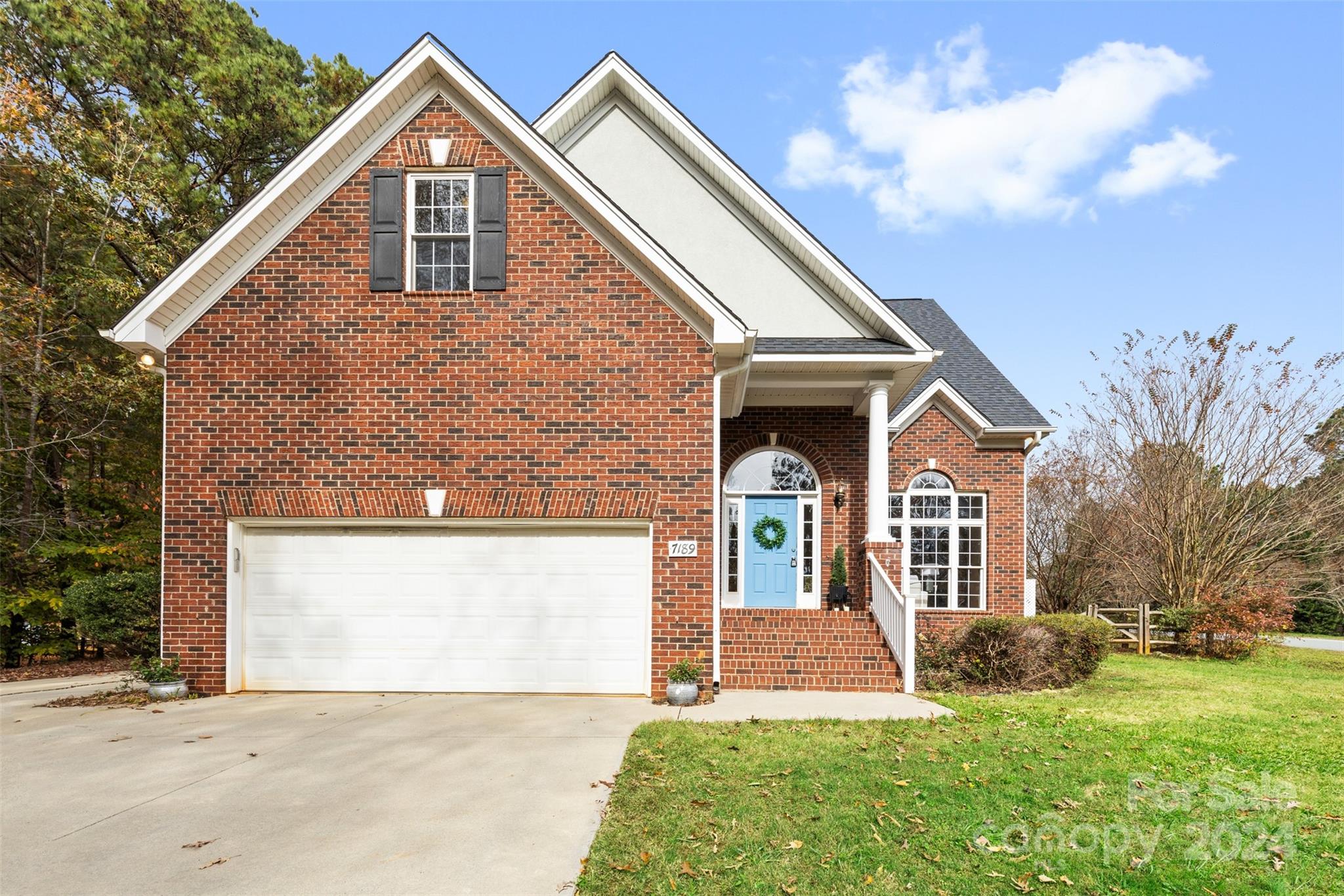 7189 Windy Pine Circle Denver, NC 28037 - Photo 2 of 34 a front view of a house with a yard and garage