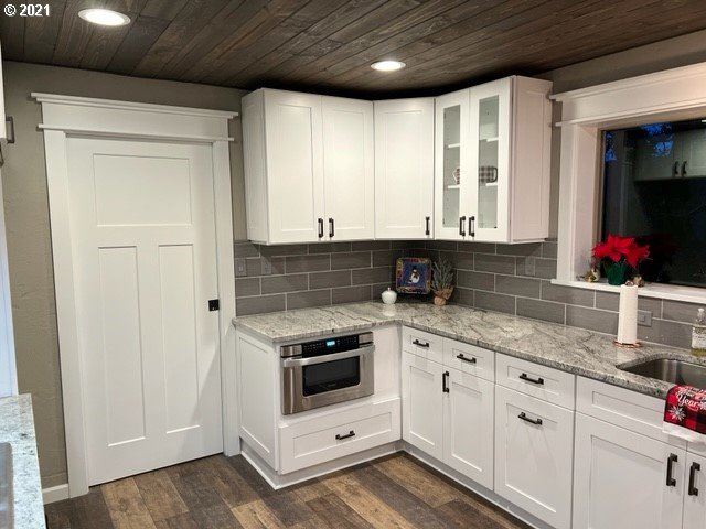 83490 Rattlesnake Road Dexter, OR 97431 - Photo 16 of 27 a kitchen with granite countertop white cabinets and white appliances