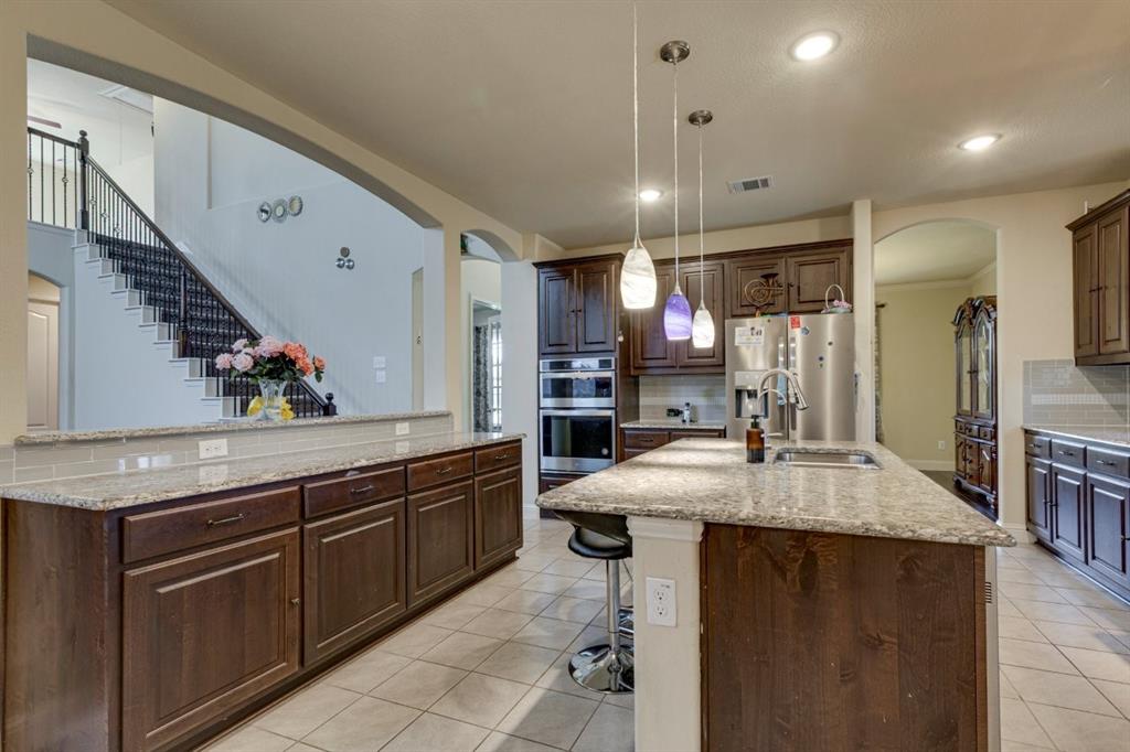 336 Red Hill Road Sunnyvale, TX 75182 - Photo 11 of 36 a kitchen with kitchen island granite countertop a sink and a stove