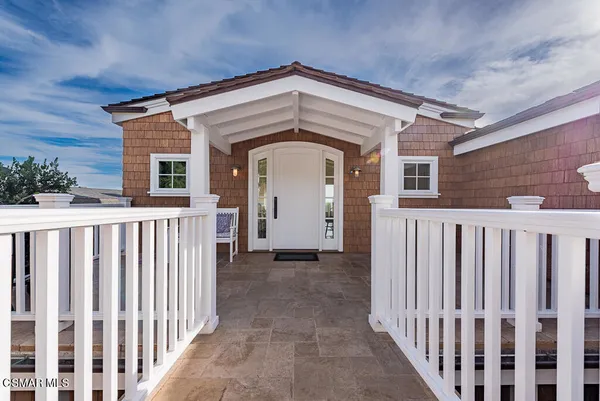 a front view of a house with wooden fence