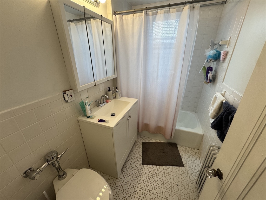 10 Alton Court, Unit 2 Brookline, MA 02446 - Photo 11 of 17 a bathroom with a sink toilet and shower