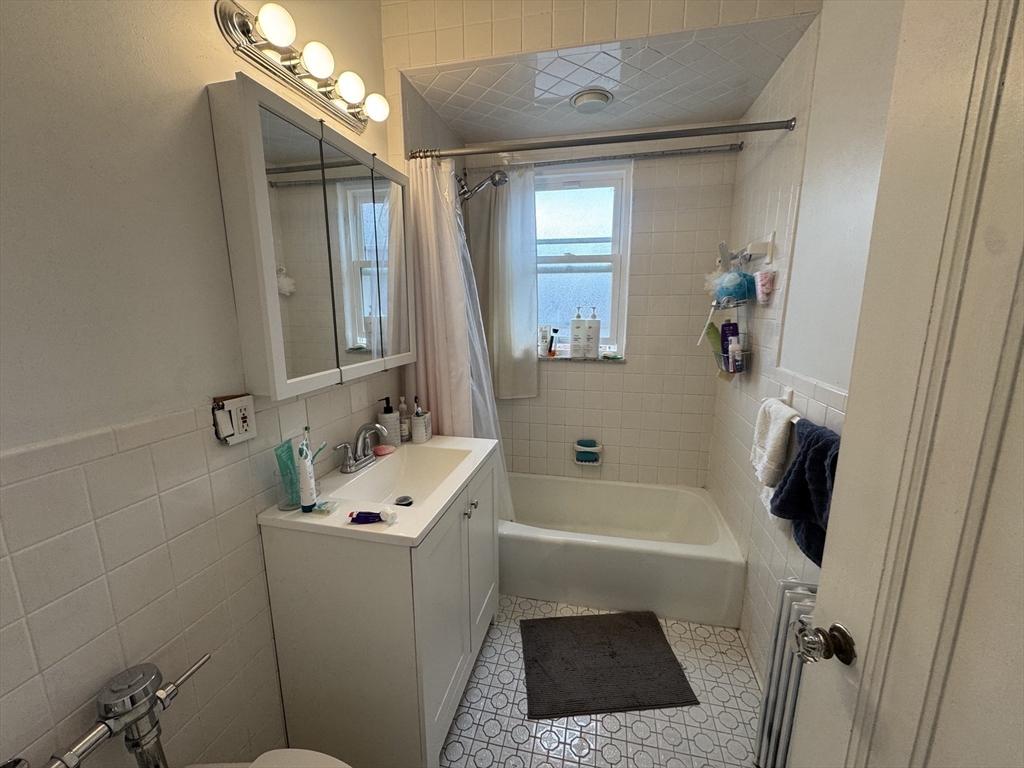 10 Alton Court, Unit 2 Brookline, MA 02446 - Photo 12 of 17 a bathroom with a sink a toilet a shower a vanity and mirror