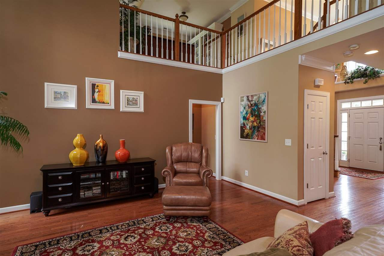 Family Room offers soaring ceilings, beautiful windows and cozy fireplace. Open to the breakfast area and kitchen. Entry to the 1st floor bed room with full bath. Family Room