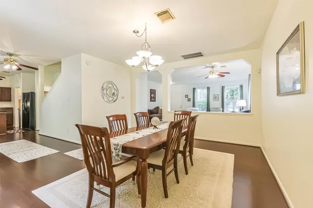 a view of a dining room with furniture and chandelier