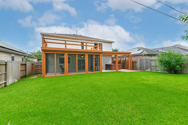 a view of a house with a backyard