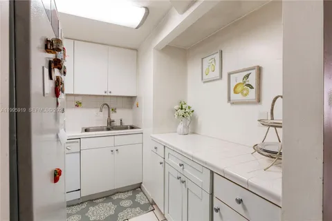 a kitchen with sink cabinets and appliances