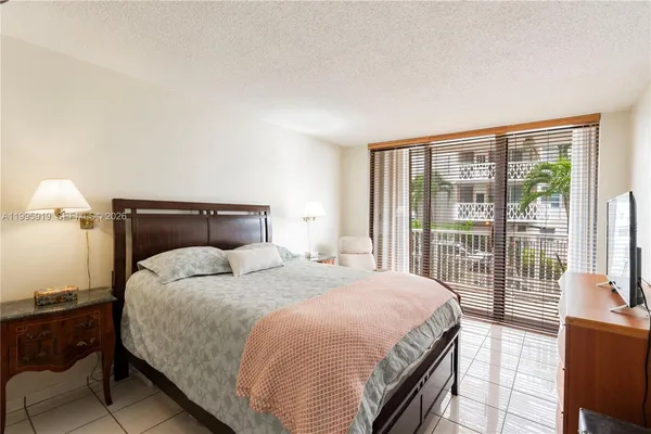 a bedroom with a large bed and a night stand