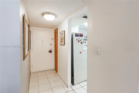 a view of a hallway with closet and entryway
