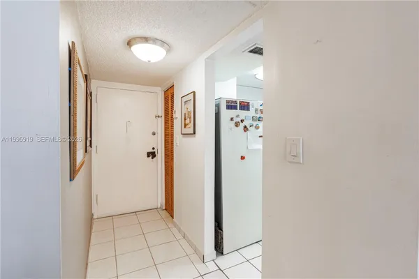 a view of a hallway with closet and entryway
