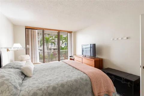 a bedroom with a large bed and a large window