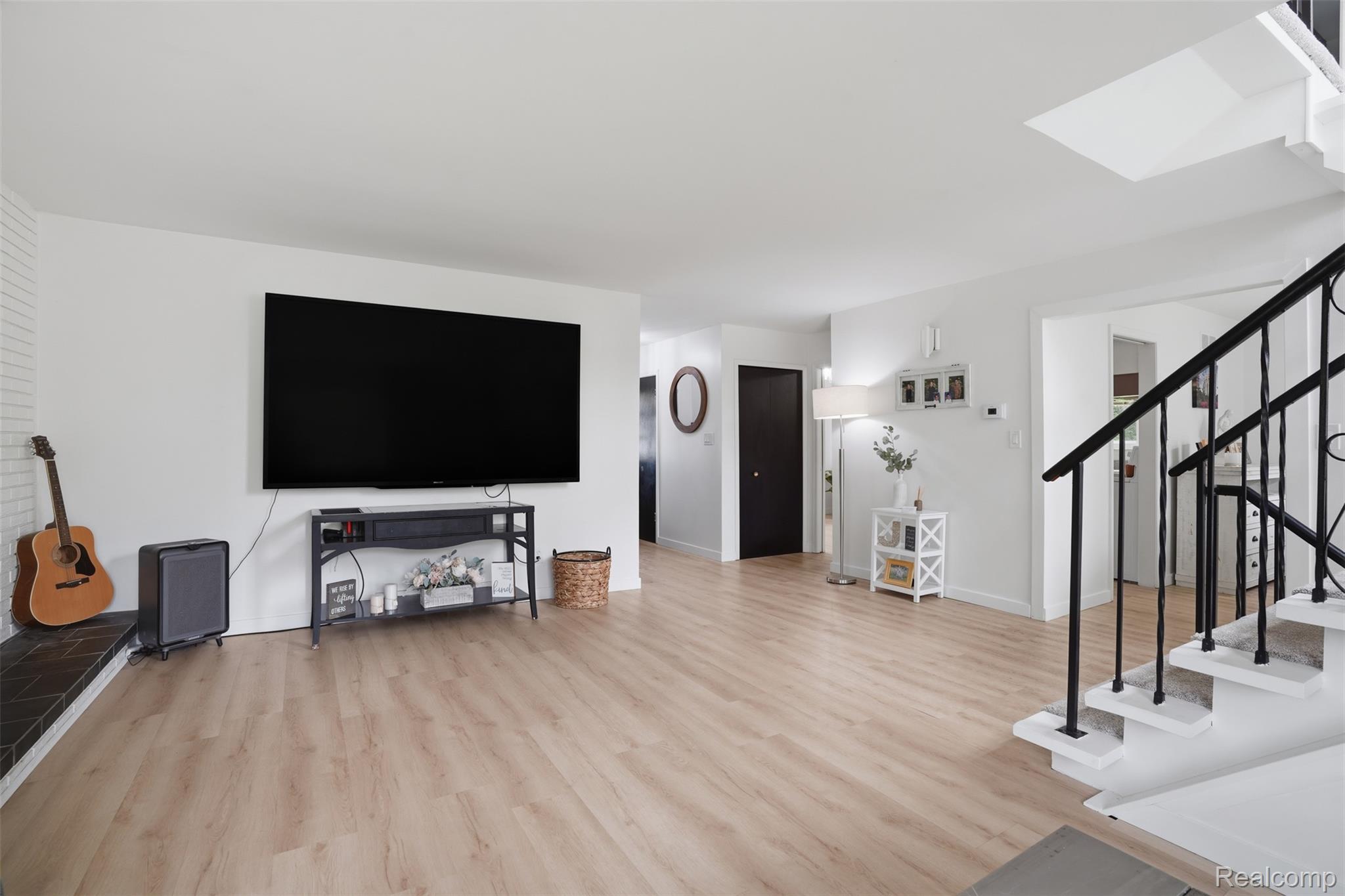 47129 Dunsany Road Northville, MI 48167 - Photo 7 of 49 Living area featuring light wood finished floors and a skylight
