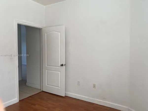 an empty room with wooden floor