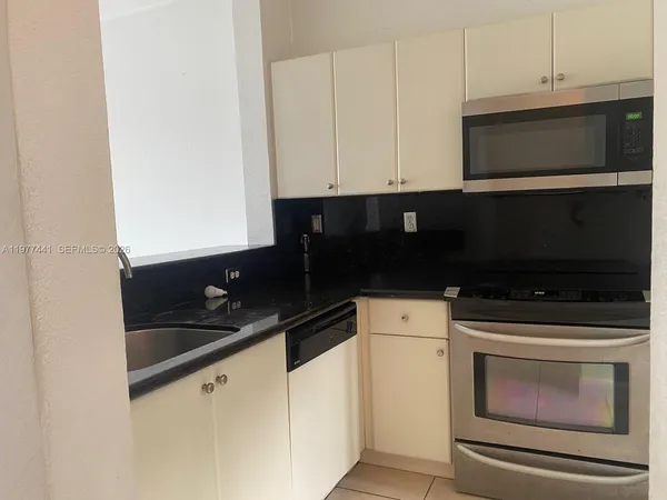 a kitchen with a sink and cabinets