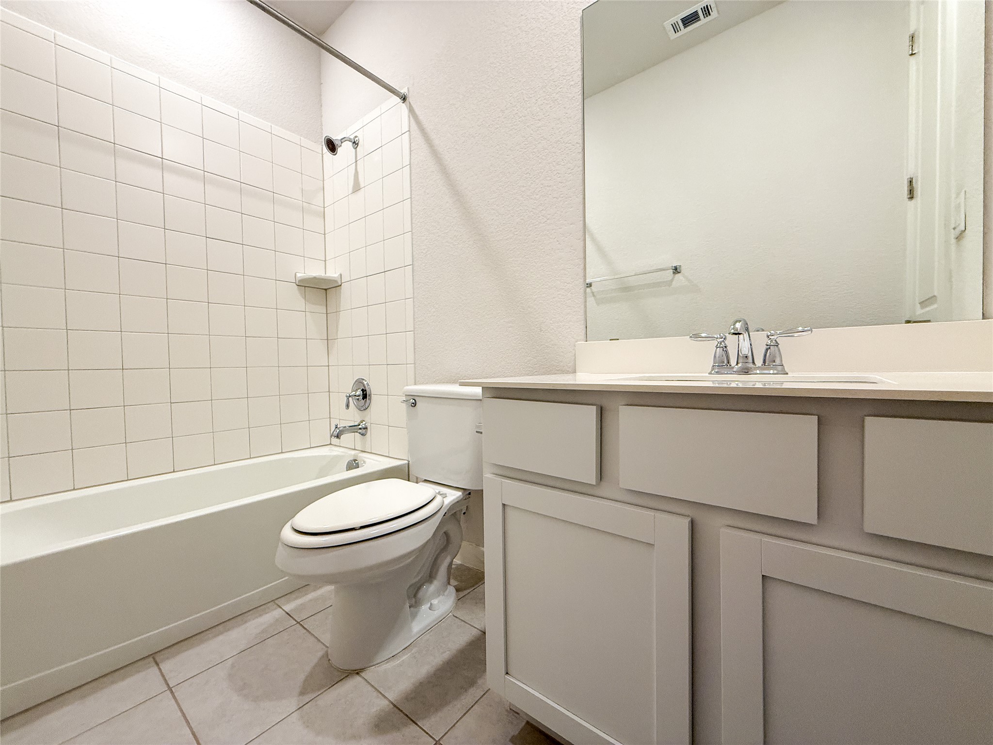 249 Heartleaf Road San Marcos, TX 78666 - Photo 24 of 38 A well-appointed bathroom with tile flooring, a bathtub, and a vanity, offering comfort and style.