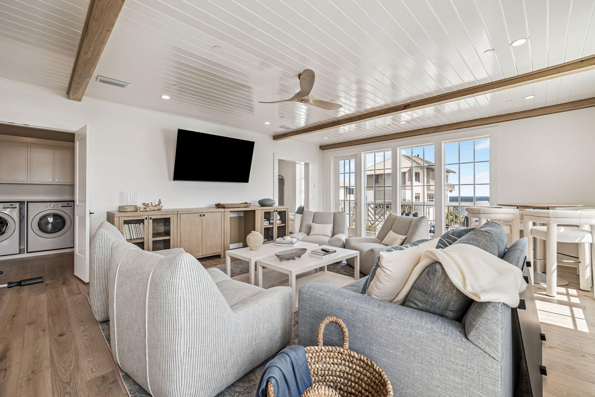 80 Green St Inlet Beach Inlet Beach, FL 32461 - Photo 58 of 111 a living room with furniture a flat screen tv and a floor to ceiling window