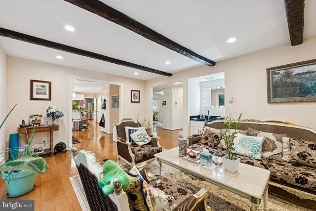 a living room with furniture a fireplace and a floor to ceiling window