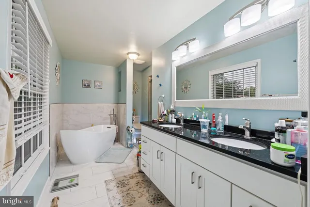 a balcony with wooden floor table and chairs