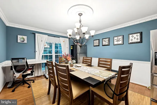 a view of a dining room with furniture and a chandelier