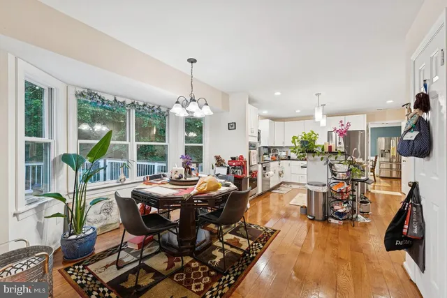 a kitchen with stainless steel appliances kitchen island granite countertop a white cabinets and stove top oven