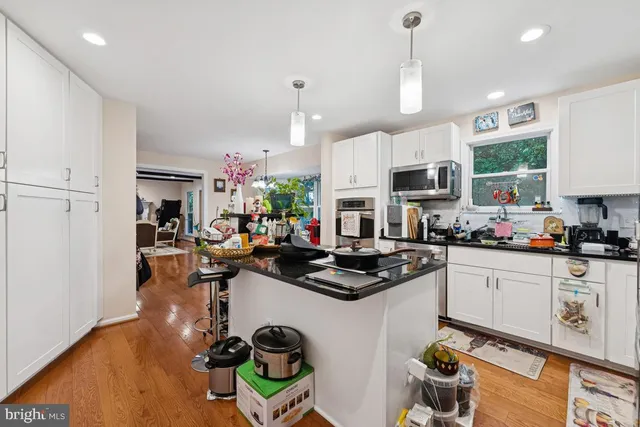 a kitchen with a sink appliances and cabinets