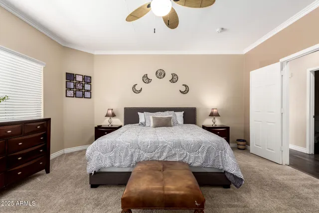 a bedroom with a bed and a painting on the wall