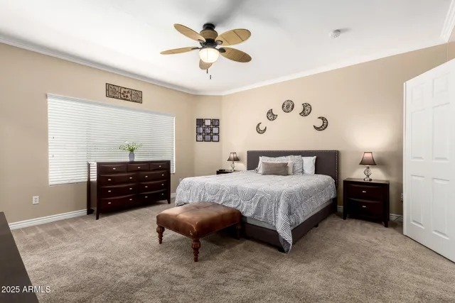 a spacious bedroom with a bed and a chandelier
