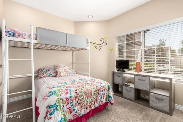 a bedroom with a bed and a desk